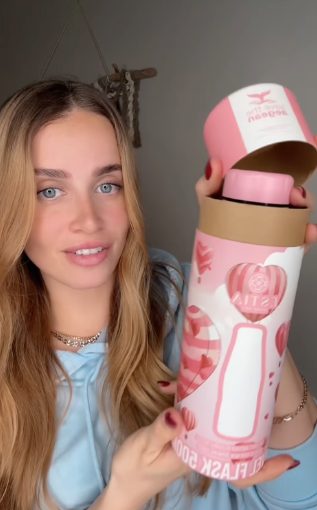 A customer unboxing an Estia flask